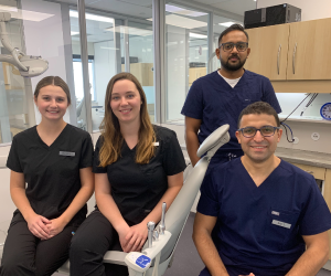 Four dental students in a dental clinic