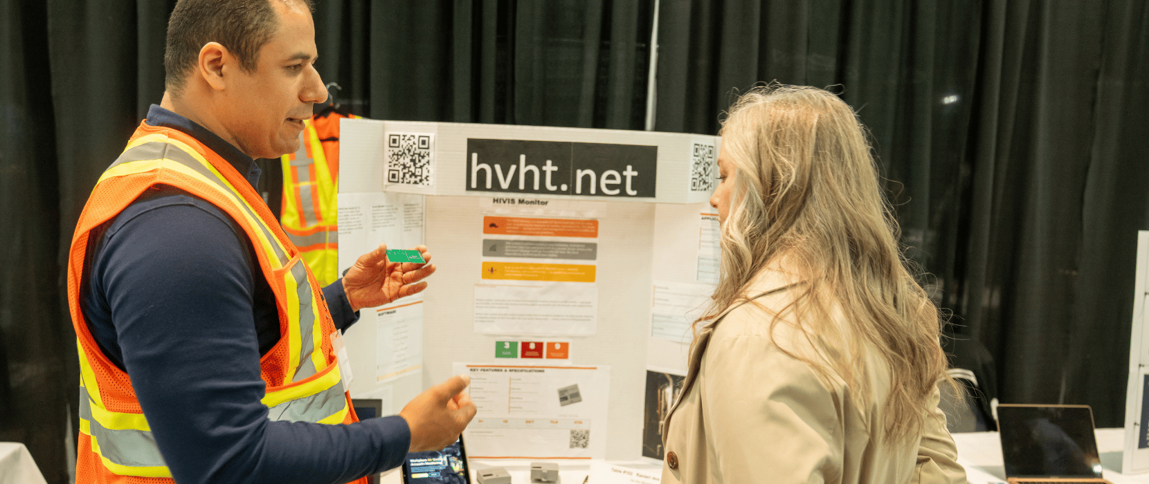 Showcase event 2026 - Two people discussing a presentation board titled 