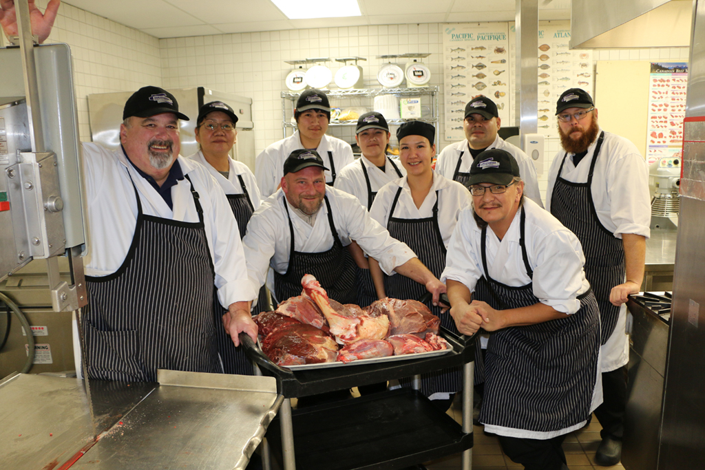 Retail meat students process bison for food bank