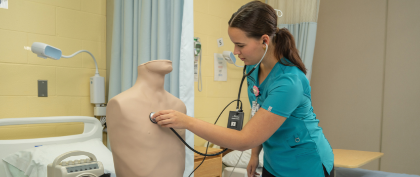 Abbie Shynkaruk in her scrubs in a nursing lab
