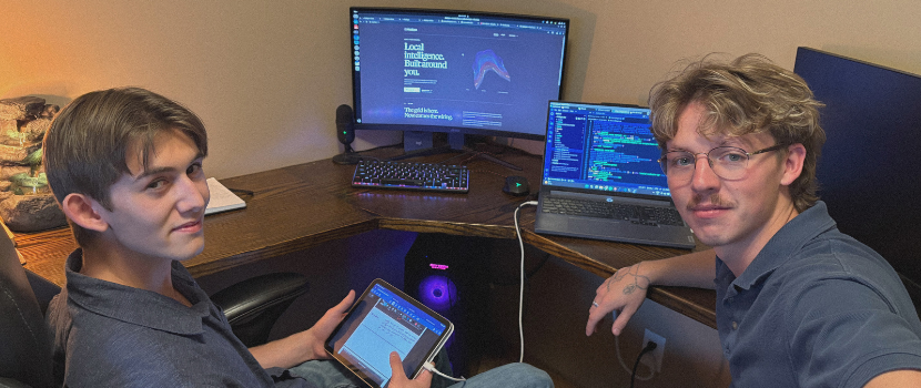 Two students in front of a computer
