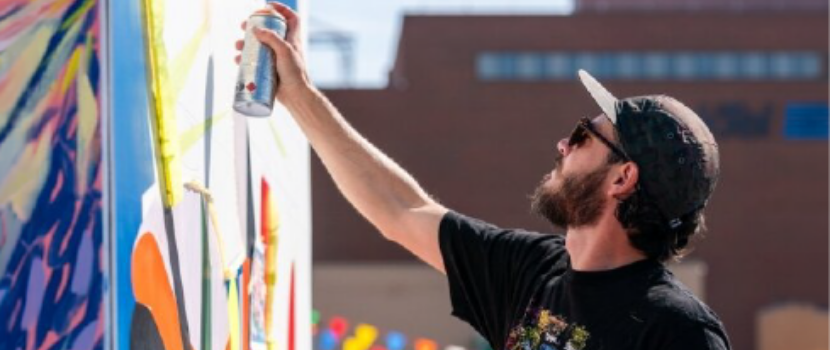 Josh spray painting a mural