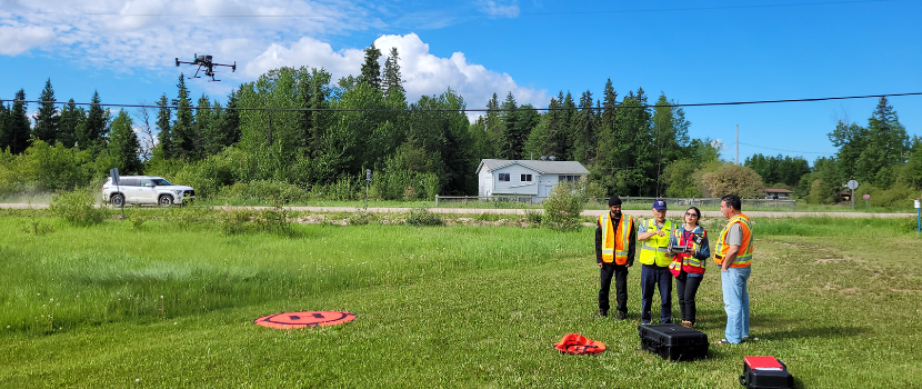 three people flying a drone